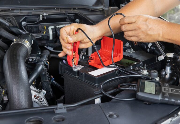 An expert is testing and repairing a car battery in Central Minnesota